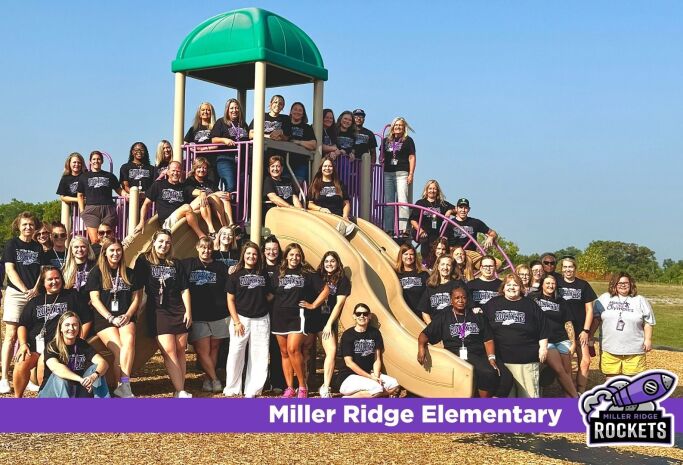 staff photo at the playground with the Miller Ridge logo